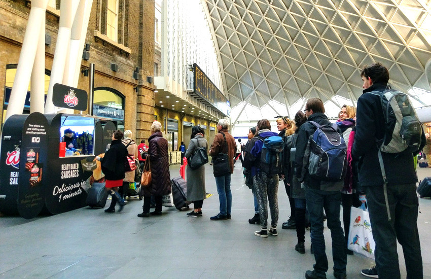 iMP sampling agency distributing sausage sandwiches at Kings Cross Station for Wall's