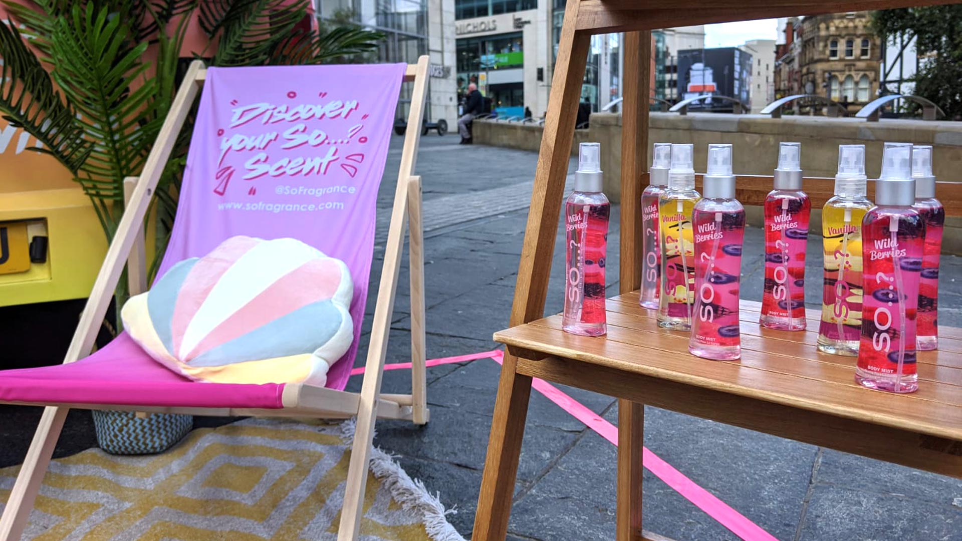 Premium high-street product display stand showcasing So Fragrance body mists and scents at an outdoor experiential roadshow