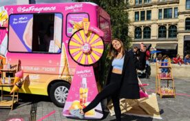 Lifestyle content creator posing with an ice cream cone at a custom iMP mobile beauty roadshow activation