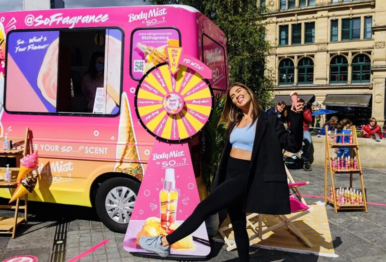 Lifestyle content creator posing with an ice cream cone at a custom iMP mobile beauty roadshow activation