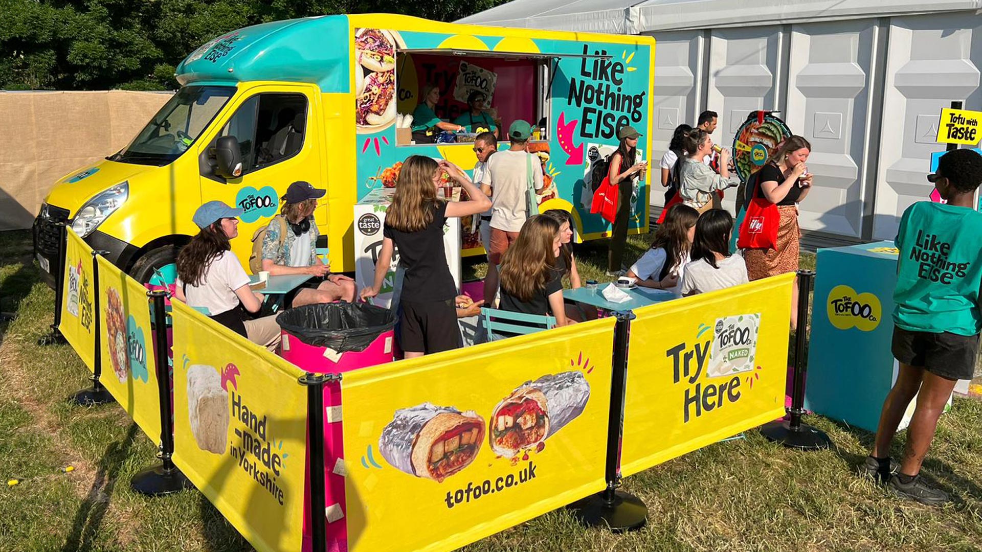 Tofoo branded van offering product samples to crowd of people