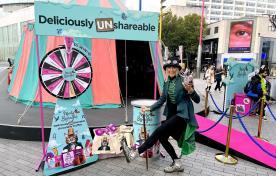 Brand ambassador posing in front of the Monty Bojangles sampling tent.
