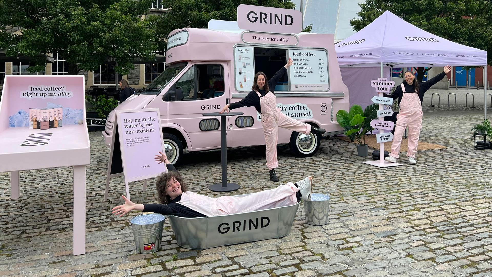 Branded Pink Grind Ice Cream van with open serving window for sampling at activation event