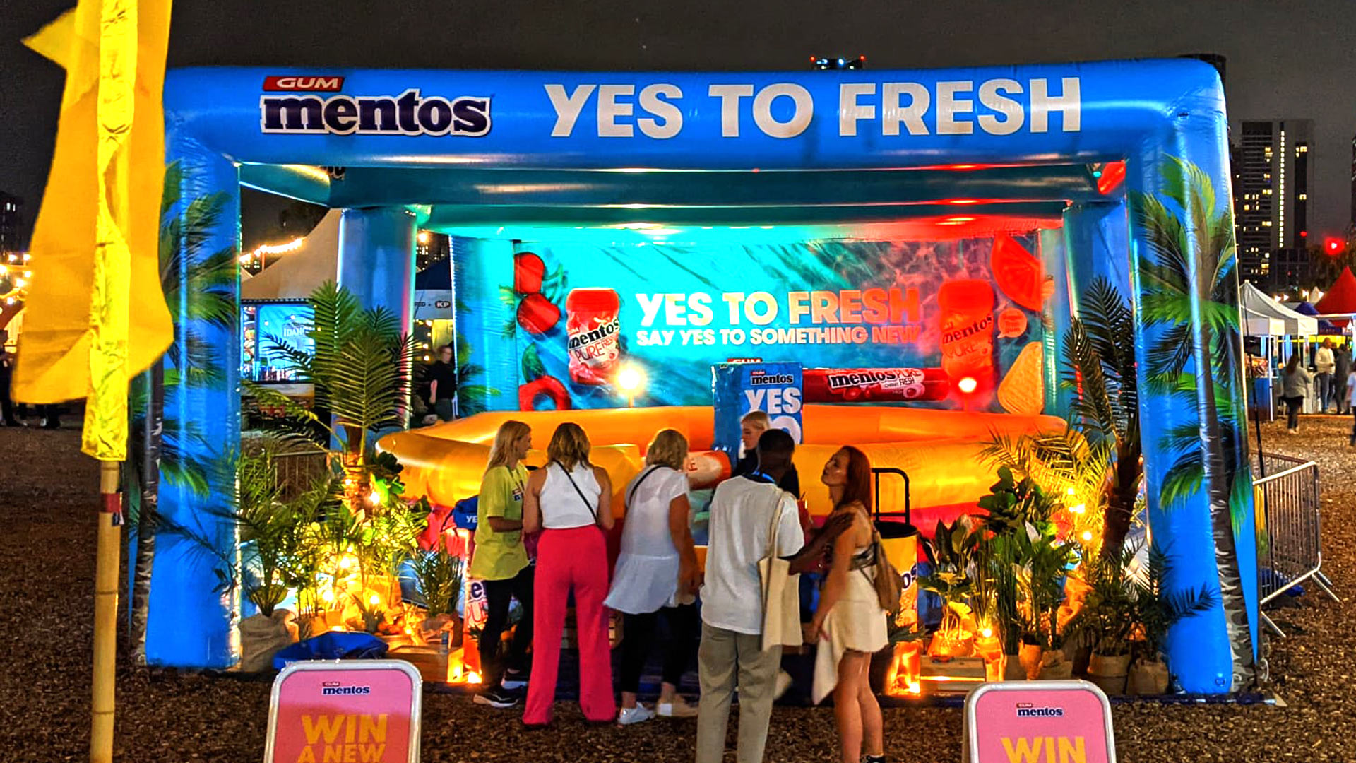 Festival attendees exploring the illuminated Mentos ‘Yes To Fresh’ inflatable brand activation at Barcode Festival