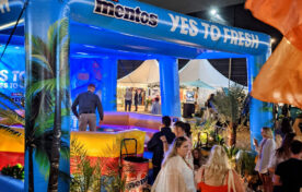 Consumers engaging with Mentos inflatable activation during evening session at Barcode Festival