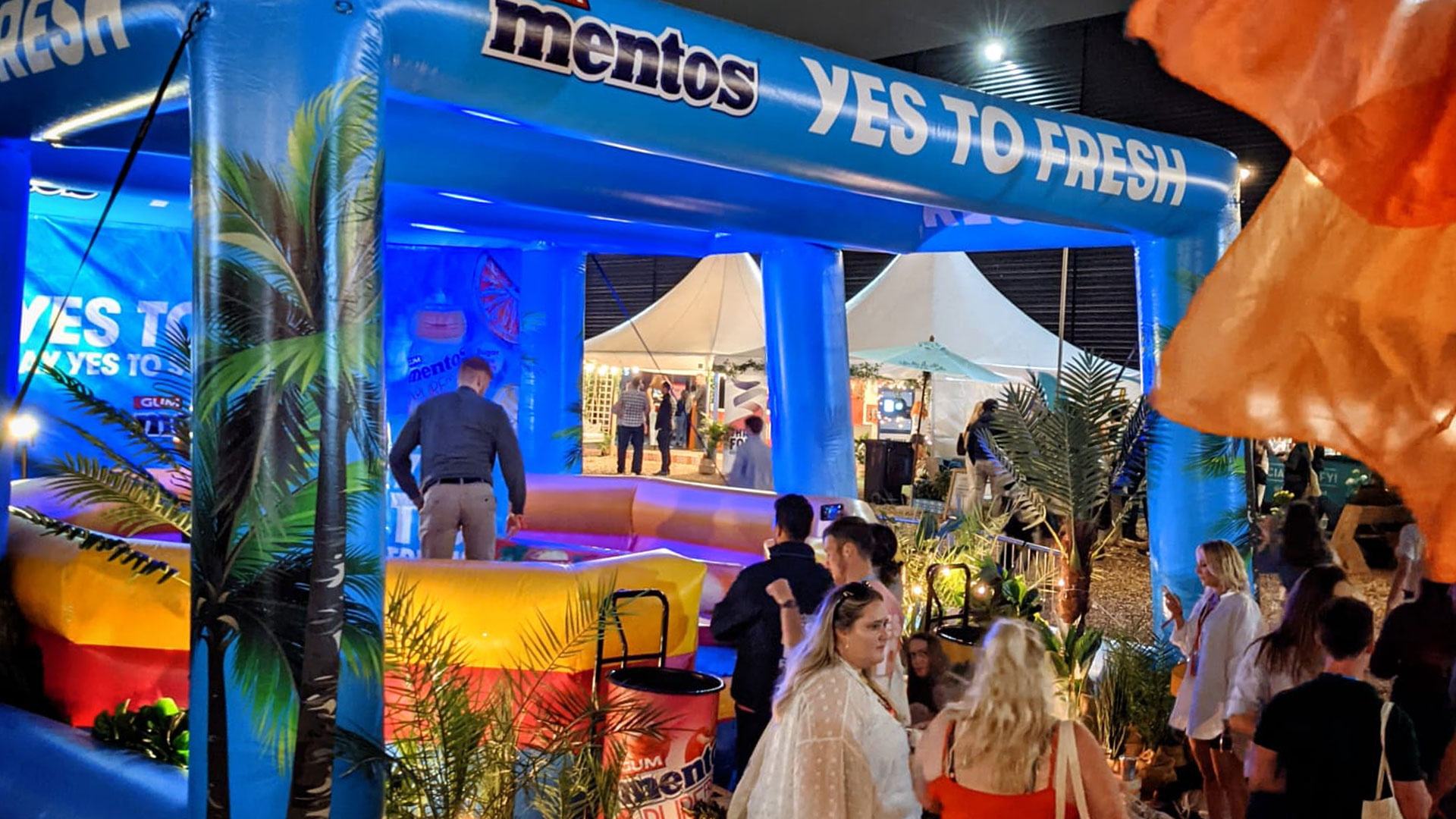 Consumers engaging with Mentos inflatable activation during evening session at Barcode Festival
