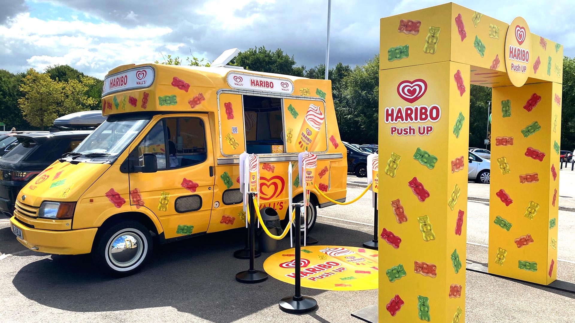 Haribo activation zone with archway, floor graphics, and café posts at ASDA