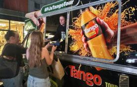 University students receiving free pizza and Tango cans from the iMP campus sampling van at student event