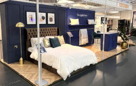 Immersive Snuggledown exhibition stand designed as a bedroom set to showcase product experience
