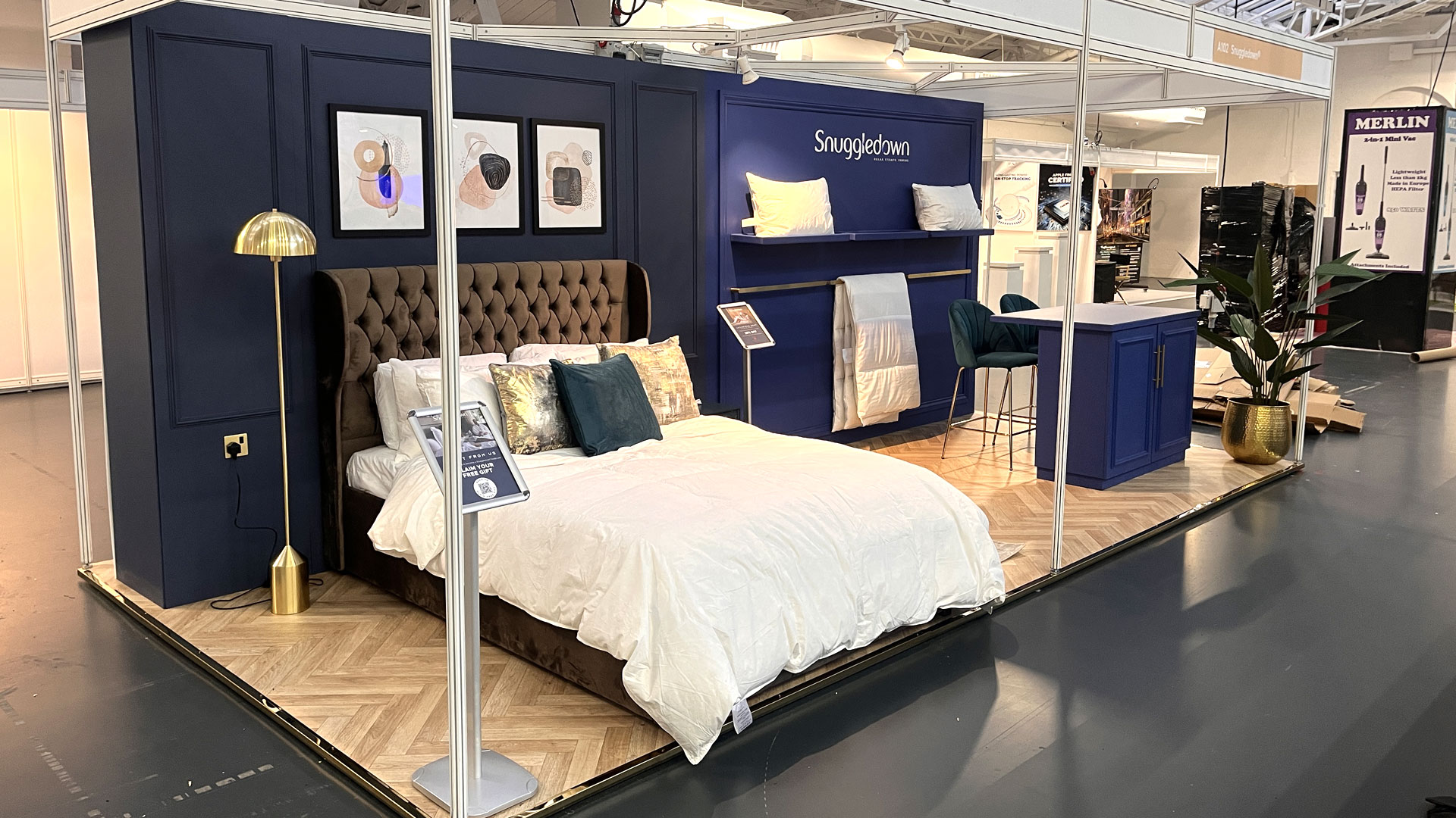Immersive Snuggledown exhibition stand designed as a bedroom set to showcase product experience