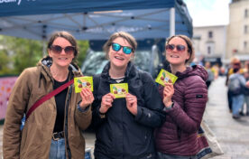 Smiling consumers holding free Ritter Sport Pistachio 100g chocolate bars